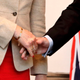 Man (R) shaking hands with woman (L). Photo: AP